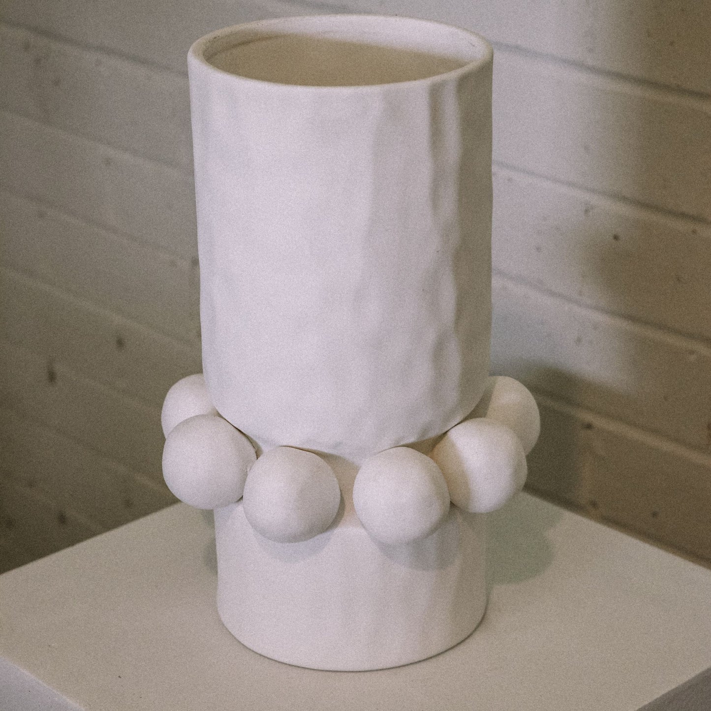 white modern cylinder vase with sphere detail