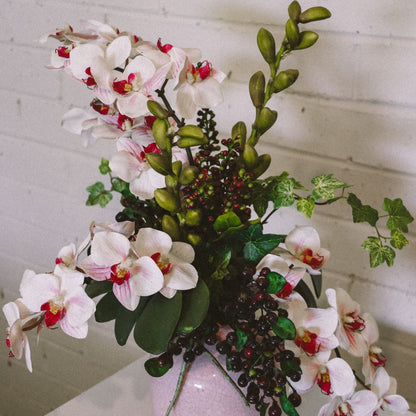 Pink and white Orchids , buds and berries with ivy